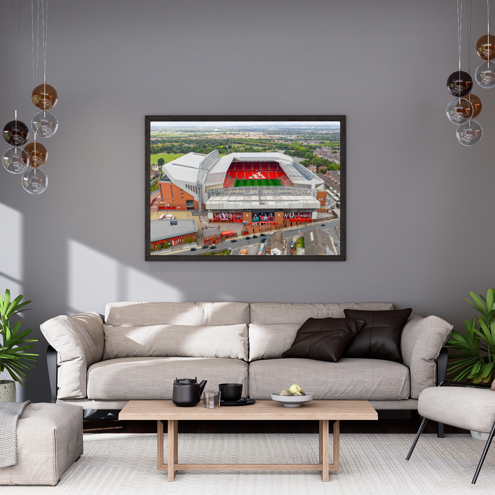 Aerial view of Anfield Stadium in Liverpool, England, featuring the iconic red seating of Liverpool FC surrounded by residential neighbourhoods and green parkland.