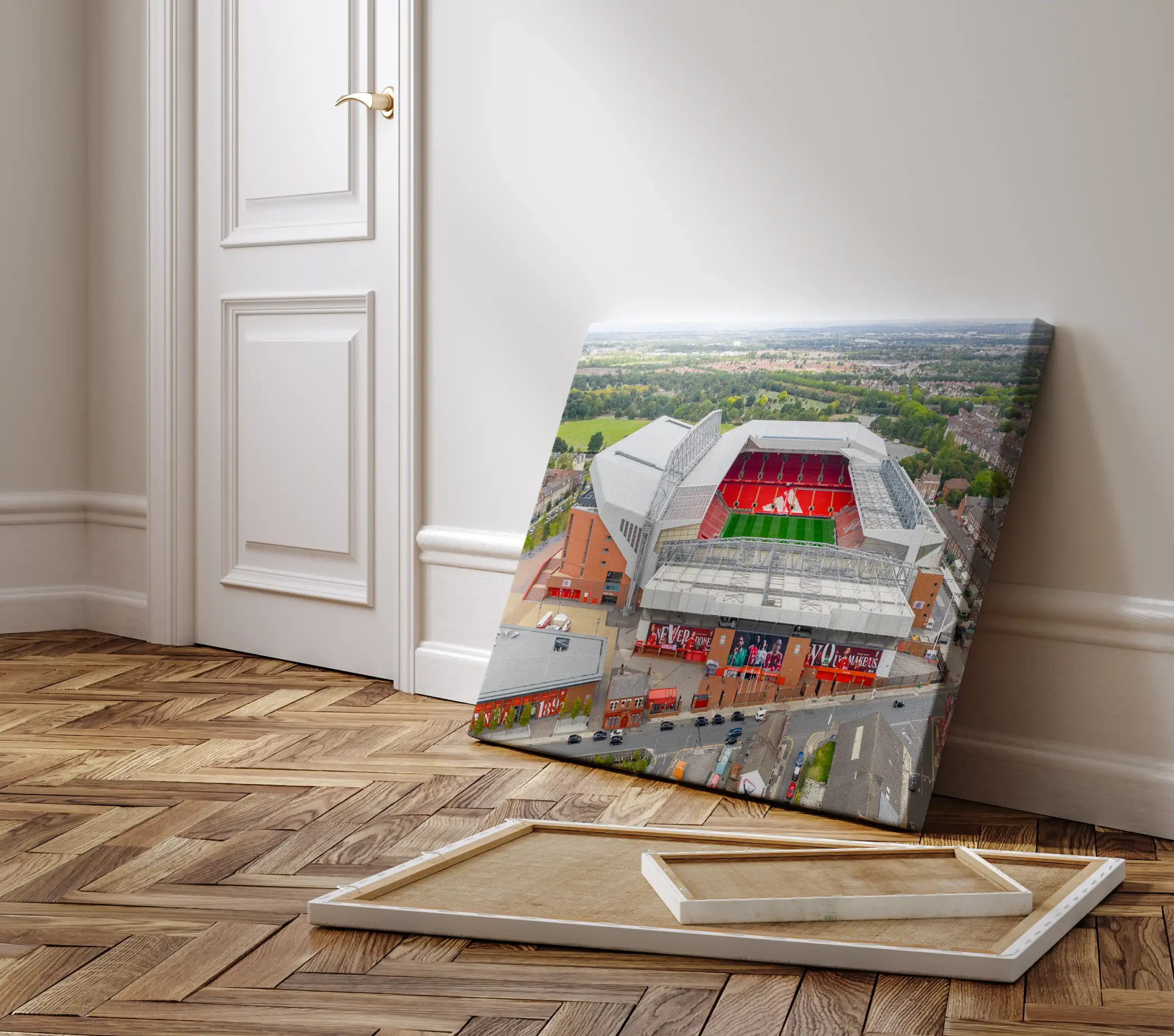 Aerial view of Anfield Stadium in Liverpool, England, featuring the iconic red seating of Liverpool FC surrounded by residential neighbourhoods and green parkland.