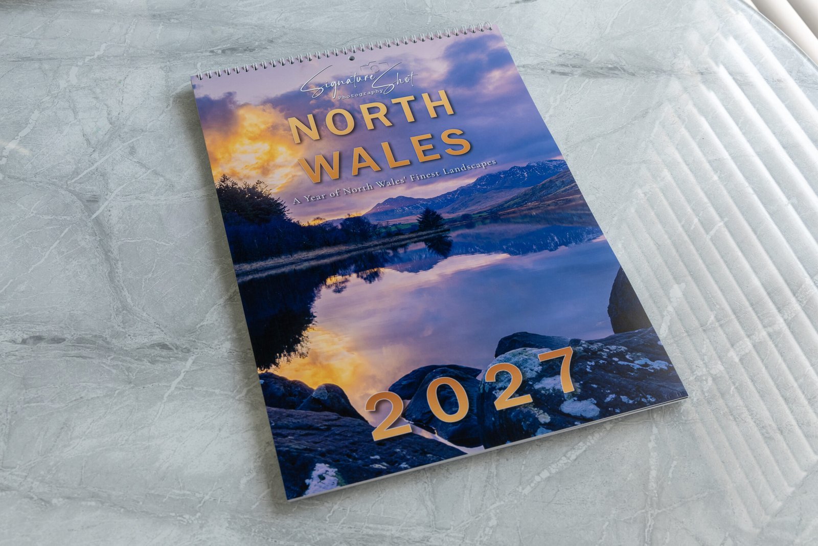 Complete North Wales 2027 calendar photographed on a premium marble surface