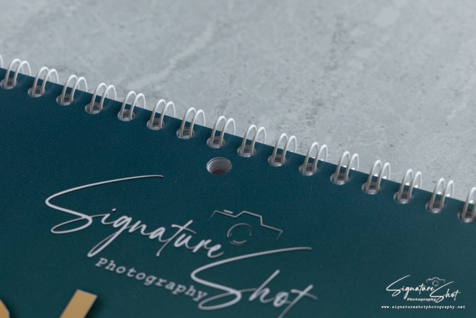 Close-up of the premium white wire binding and hanging hole